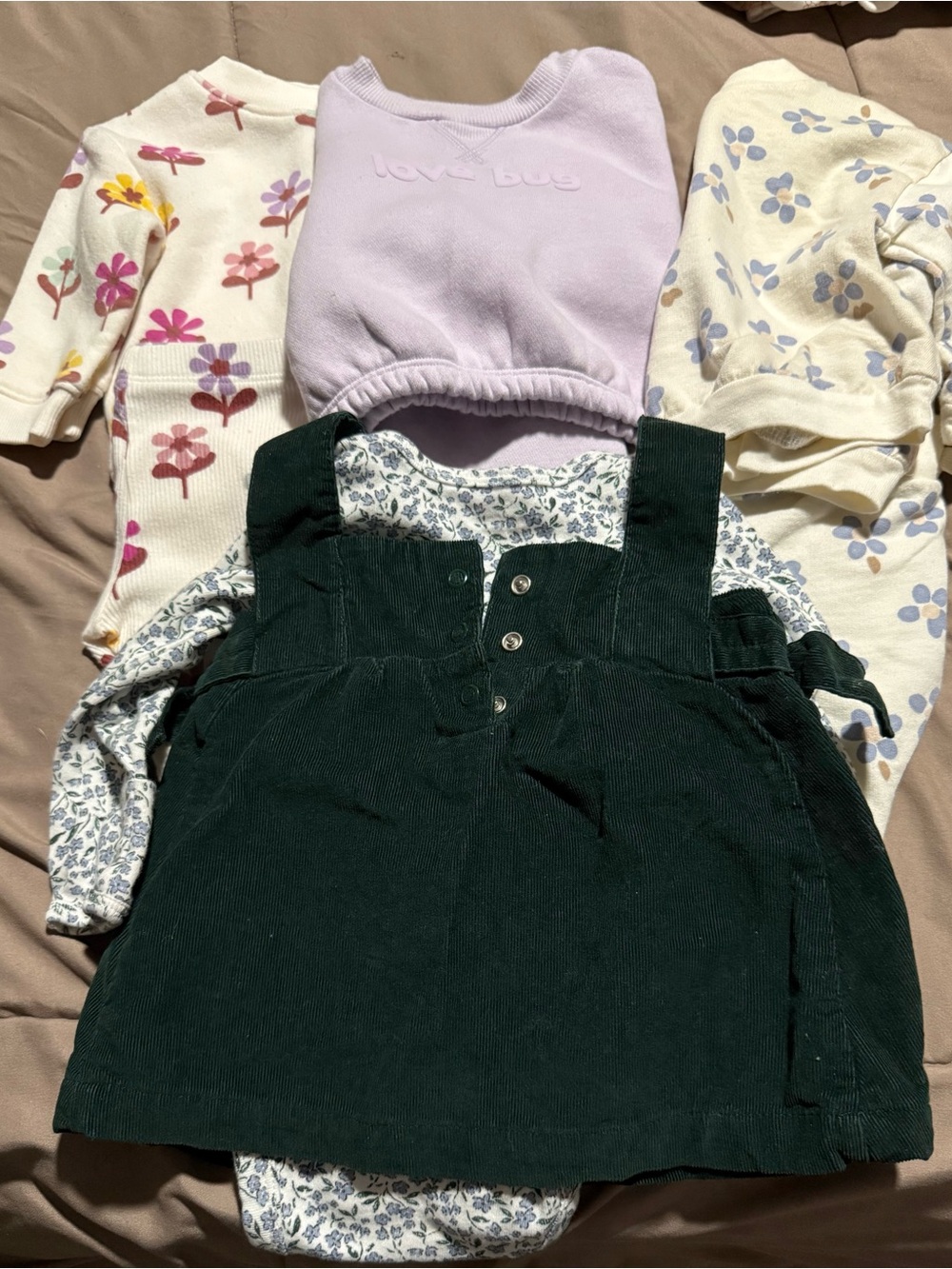 3 months. Baby girl sweat outfits and green corduroy dress.